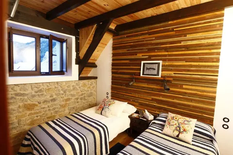 A timber-lined bedroom at the Wild Trout lodge