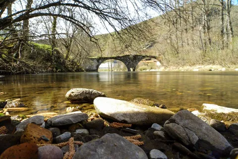 An old stone bridge over a Leonese river